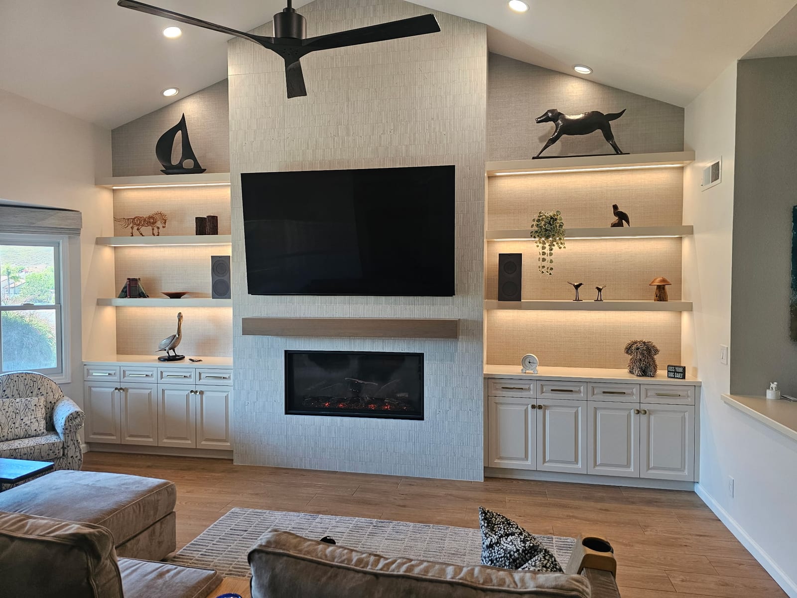 Custom living room feature wall with tile fireplace surround and built-in shelving